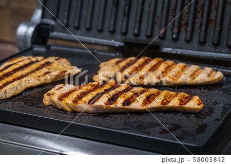 Turkey fillet steaks grilled in the home kitchen. Horizontal orientation 58003842