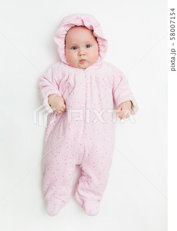 Cute baby dressed in warm overall for winter cold weather. 58007154