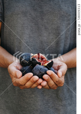 man with some figs in his hands 58009313