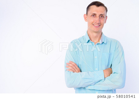 Studio shot of happy businessman smiling with arms crossed 58010541