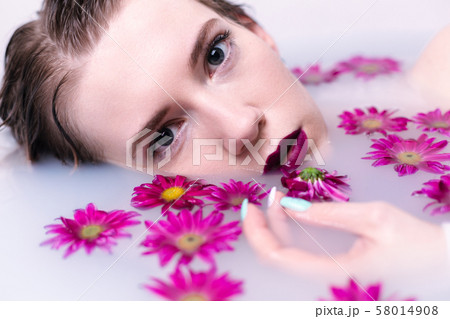 Beautiful fashion model girl taking milk bath 58014908