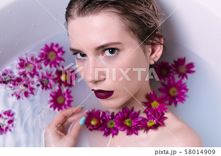 Beautiful fashion model girl taking milk bath Beautiful fashion model girl taking milk bath 58014909