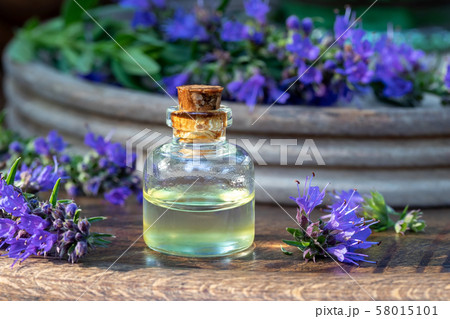 A bottle of essential oil with fresh blooming hyssop A bottle of essential oil with fresh blooming hyssop 58015101