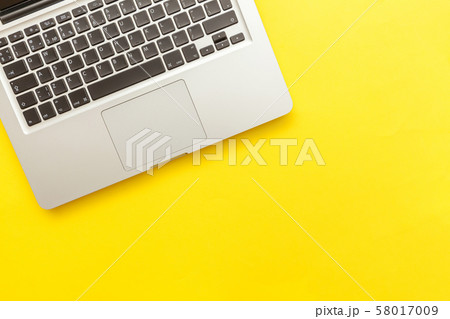 Keyboard laptop computer isolated on yellow desk 58017009