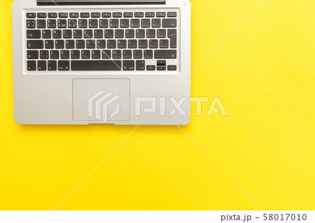 Keyboard laptop computer isolated on yellow desk 58017010