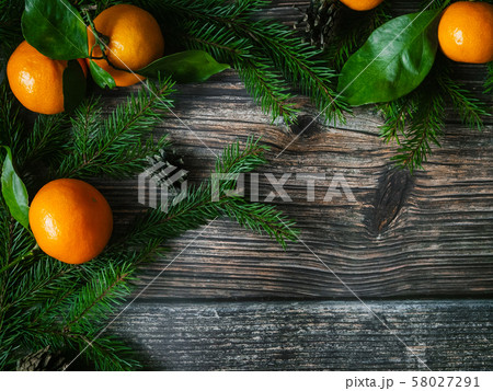 tangerines and fir branches on wooden background for Christmas holiday 58027291