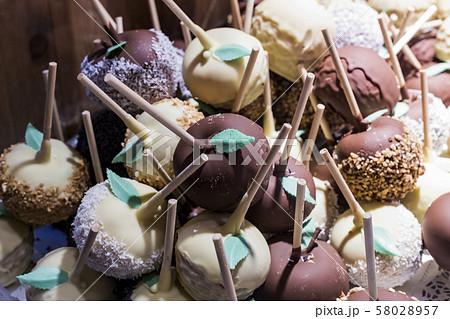 Fruits bananas, strawberries, nuts, apples, peaches drenched in white and dark chocolate. Fruits bananas, strawberries, nuts, apples, peaches drenched in white and dark chocolate. 58028957