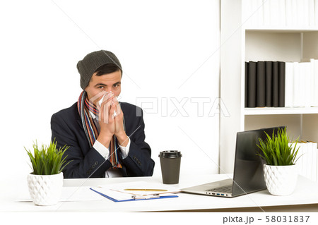 Young asian business man blows his nose while 58031837