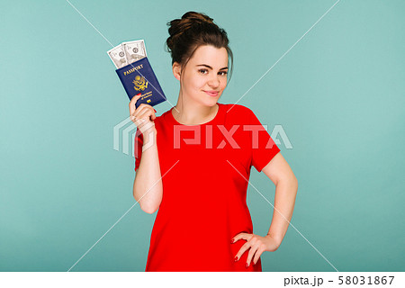 A handsome mature woman holding a passport with 58031867