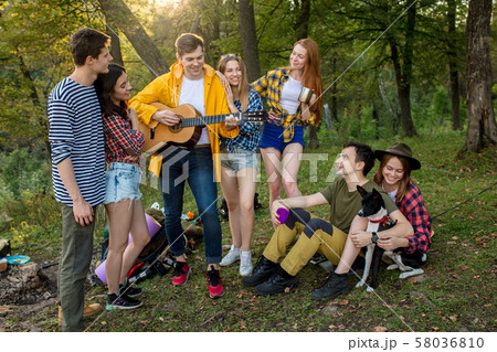 young positive tourists celebrating their successful travel 58036810