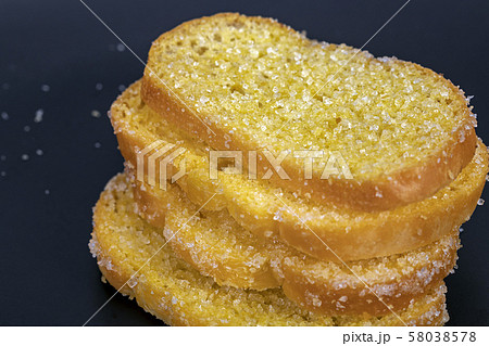 Delicious crisp sliced butter toast on black plate 58038578