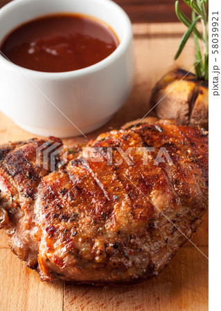 Grilled pork steak with ketchup, garlic, rosemary Grilled pork steak with ketchup, garlic, rosemary 58039921