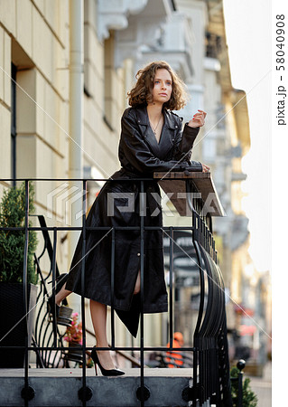 Beautiful lady standing on balcony Beautiful lady standing on balcony 58040908