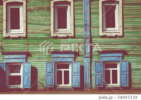 Window with the wooden carved architrave in the old wooden house in the old Russian town. Irkutsk Window with the wooden carved architrave in the old wooden house in the old Russian town. Irkutsk 58041538