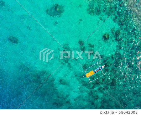 Couple snorkeling in the blue sea ocean and coral background aerial top view 58042008
