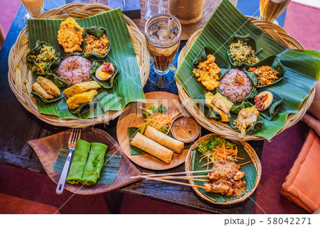 Nasi lemak, Nasi campur, Indonesian Balinese rice with potato fritter, sate lilit, fried tofu, spicy Nasi lemak, Nasi campur, Indonesian Balinese rice with potato fritter, sate lilit, fried tofu, spicy 58042271