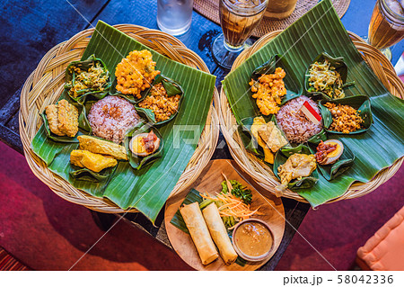 Nasi lemak, Nasi campur, Indonesian Balinese rice with potato fritter, sate lilit, fried tofu, spicy 58042336