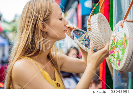 Woman traveler choose souvenirs in the market at Ubud in Bali, Indonesia 58042992