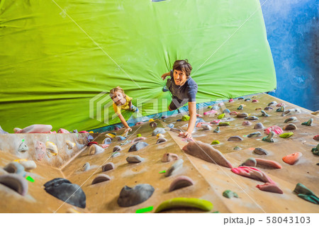 Dad and son at the climbing wall. Family sport, healthy lifestyle, happy family 58043103