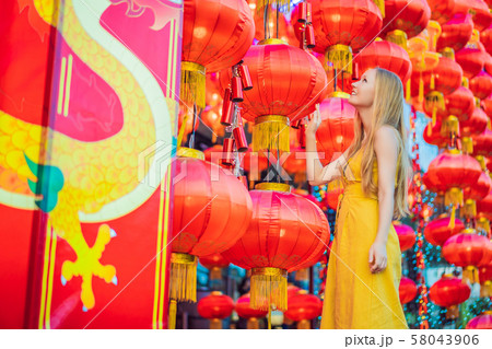 Woman celebrate Chinese New Year look at Chinese red lanterns. Chinese lanterns 58043906