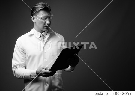 Man doctor wearing protective glasses shot in black and white 58048055