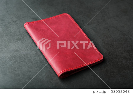 Red leather cover for a passport on a dark Red leather cover for a passport on a dark 58052048