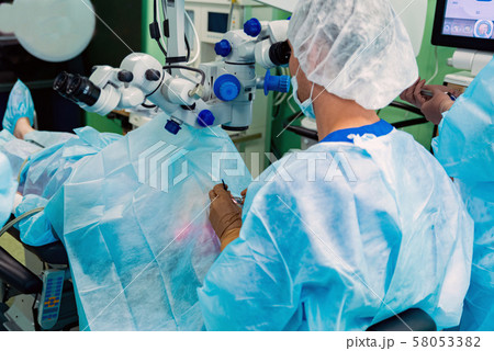Doctors perform eye lens replacement operation with modern equipment 58053382