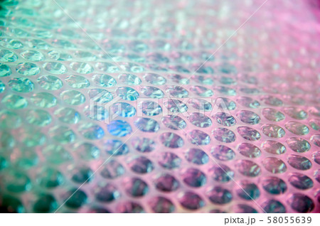 Holographic background in the style of the 80-90s. Real texture of bubble wrap film in bright acid Holographic background in the style of the 80-90s. Real texture of bubble wrap film in bright acid 58055639