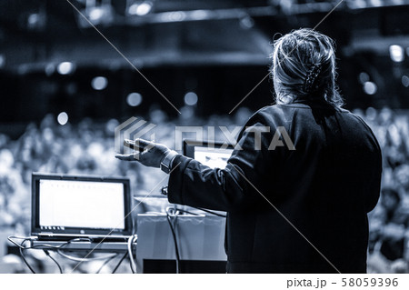 Public speaker giving talk at Business Event. 58059396