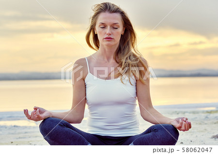 Woman do meditation outdoors 58062047