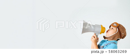 Cute funny girl with megaphone on color 58063269