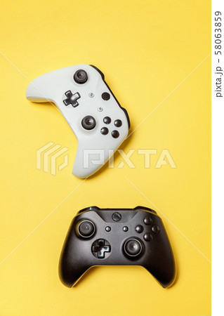 White and black two joystick on yellow background. White and black two joystick on yellow background. 58063859