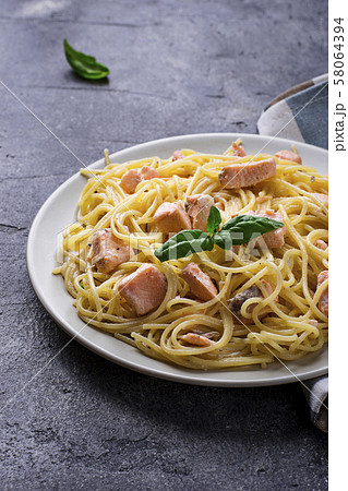 Pasta spaghetti with salmon and basil 58064394