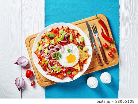 homemade chilaquiles with a fried egg, close-up 58065109