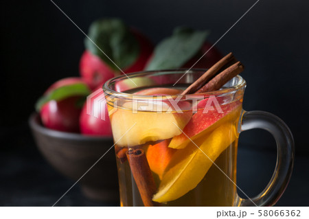 Glass of tea with lemon, spiced, sliced apple . 58066362