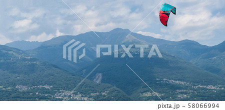 Lake Como, Italy - July 21, 2019. Kitesurfing parachute flies in the sky 58066994