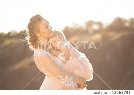 Portrait of a beautiful young mom holds her Portrait of a beautiful young mom holds her 58068791