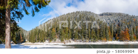 The first snow on a lake in a mountain forest The first snow on a lake in a mountain forest 58069904