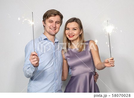 Party, new year, christmas and holidays concept - young couple celebrating their anniversary with 58070028