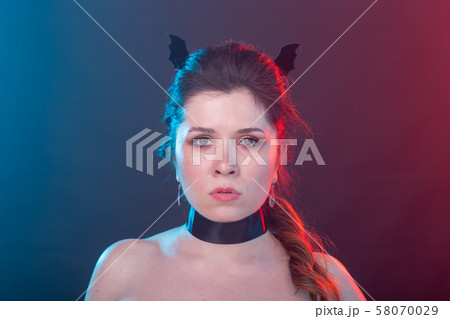 Halloween, holidays and carnival concept - vamp woman in gothic style. 58070029