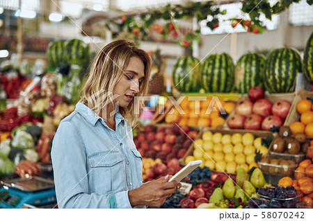 Calm woman with notebook at the market stock photo 58070242