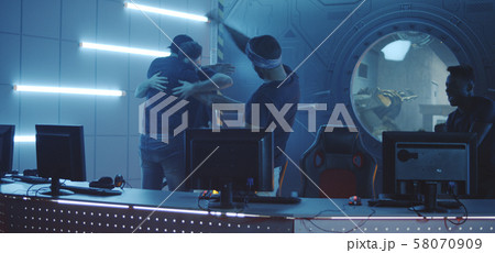Gaming team sitting down at their desks 58070909
