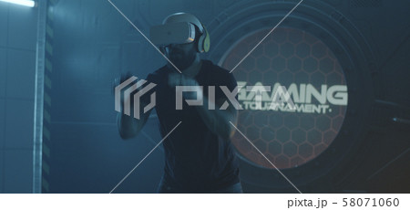 Gamer playing with VR action game Gamer playing with VR action game 58071060