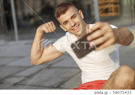 Strong young man taking a selfie outside 58071433