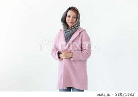 Cheerful young slim woman posing in pink coat with hood over white background. Concept of love for Cheerful young slim woman posing in pink coat with hood over white background. Concept of love for 58071932