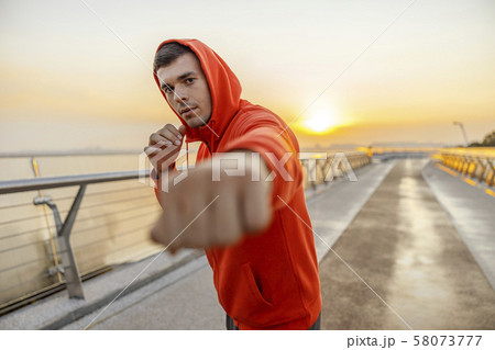 Caucasian young sportsman exercising on a bridge 58073777