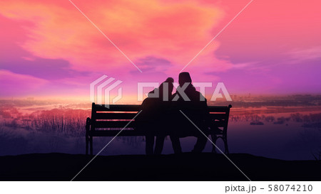 Couple on a bench looks at a winter landscape. 58074210