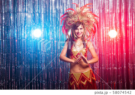 Cabaret, dancer and holidays concept - Cute young girl in bright colorful carnival costume on dark Cabaret, dancer and holidays concept - Cute young girl in bright colorful carnival costume on dark 58074542
