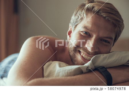 Young man being cheerful after waking up Young man being cheerful after waking up 58074978