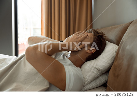 Sleepy man beginning his morning waking up Sleepy man beginning his morning waking up 58075128